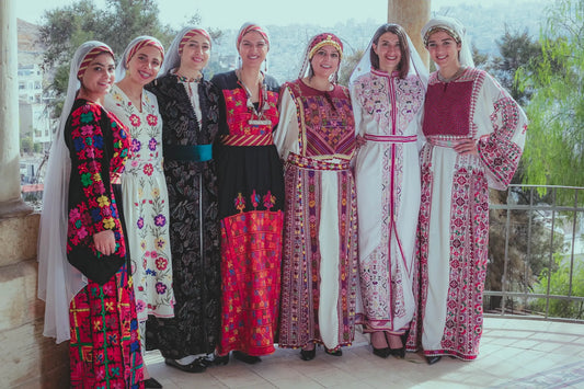 palestinian women wearing tradional embroidered thob 